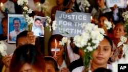 FILE - Relatives of victims of then-President Rodrigo Duterte's so-called war on drugs hold a memorial for their loved ones, at a church in Manila, Philippines, March 17, 2019. 