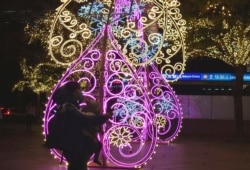 People walk pass the Christmas decorations in Taipei, Taiwan, Dec. 17, 2020.