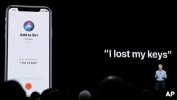 FILE - Craig Federighi, Apple's senior vice president of Software Engineering, speaks about Siri during an announcement of new products at the Apple Worldwide Developers Conference in San Jose, California, June 4, 2018. 
