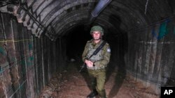 FILE - Israeli military spokesperson, Rear Adm. Daniel Hagari, speaks to the media in a tunnel that the military says Hamas militants used to attack the Erez crossing in the northern Gaza Strip, December 15, 2023.