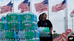 Staff at Lakewood Church hand out water and operate a cooling station in Houston, Texas, on July 9, 2024. The effects of Hurricane Beryl left most in the area without power.