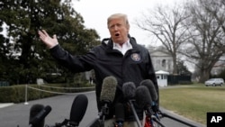 President Donald Trump talks with reporters outside the White House before traveling to Alabama to visit areas affected by the deadly tornadoes, March 8, 2019, in Washington.