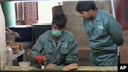 Afghan factory workers make preparations to manufacture boots at the Milli Factory in Kabul, Afghanistan