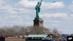 New York Police boats are docked at Liberty Island where the Statue of Liberty was evacuated while a report of a suspicious package is investigated, seen from Jersey City, N.J., April 24, 2015.
