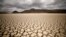 FILE - Clouds gather but produce no rain as cracks are seen in the dried up municipal dam in drought-stricken Graaff-Reinet, South Africa, Nov. 14, 2019. 