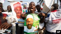 Supporters of former military leader, Muhammadu Buhari, and presidential aspirant, chant slogans during the All Progressive Congress party convention in Lagos, Nigeria,Wednesday, Dec. 10, 2014. 