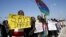 Demonstrators, most from Sudan and its Darfur region, hold placards as they protest in front of the American Embassy in Tel Aviv against human rights violations, Feb. 3, 2016.
