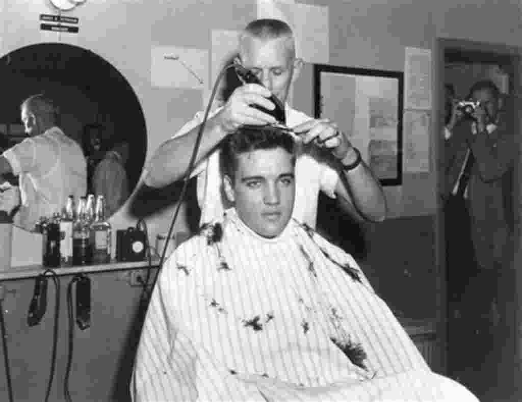 ** FILE ** In this March 1958 file photo, singer Elvis Presley gets his hair cut before entering the Army at Fort Chaffee in Barling, Ark. According the the U.S. Army, Presley entered the service March 24, 1958, at Fort Chaffee Reception Station. (AP Phot