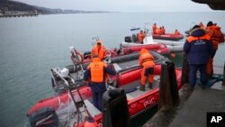 Ministry of Emergency Situations employees prepare rescue boats at a pier just outside Sochi, Russia, Dec. 26, 2016. 