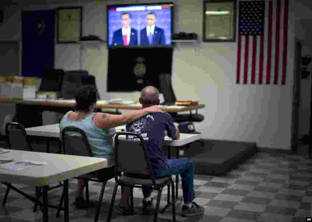Dawn, left, and Randy Cornell, watch the presidential debate at the United Steelworkers Local 4856 Union Hall in Henderson, Nevada. 