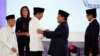 Indonesia's presidential candidate Joko Widodo shakes hands with his opponent Prabowo Subianto as their running mates Ma'ruf Amin and Sandiaga Uno smile after a televised debate in Jakarta, Indonesia, Jan. 17, 2019. 