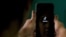 FILE - A mobile phone user opens the Chinese-owned video-sharing 'Tik Tok' app on a device in Bangalore, India, June 30, 2020.