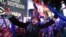 A reveler takes a photo of himself during the annual New Year's Eve celebration in Times Square on Thursday, Dec. 31, 2015.