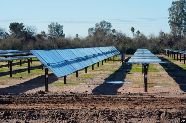 Rows of solar panels sit at Orsted's Eleven Mile Solar Center lithium-ion battery storage energy facility Thursday, Feb. 29, 2024, in Coolidge, Ariz. (AP Photo/Ross D. Franklin)