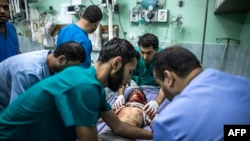 Shahed Qishtah, a nine-year-old Palestinian girl, receives medical care after she was injured in an Israeli strike while playing in northern Gaza, Kamal Adwan hospital, Beit Lahia, July 22, 2014.