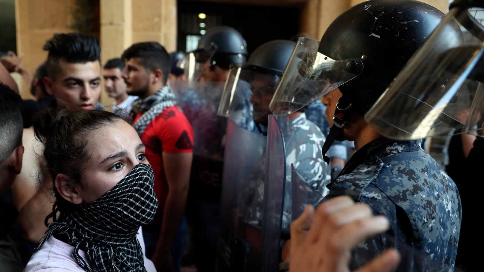 FILE - Riot police stand guard during a demonstration against the political leadership the protesters blame for the economic and financial crisis, in front of the Ministry of Economy, in downtown Beirut, Lebanon, June 6. 2021.