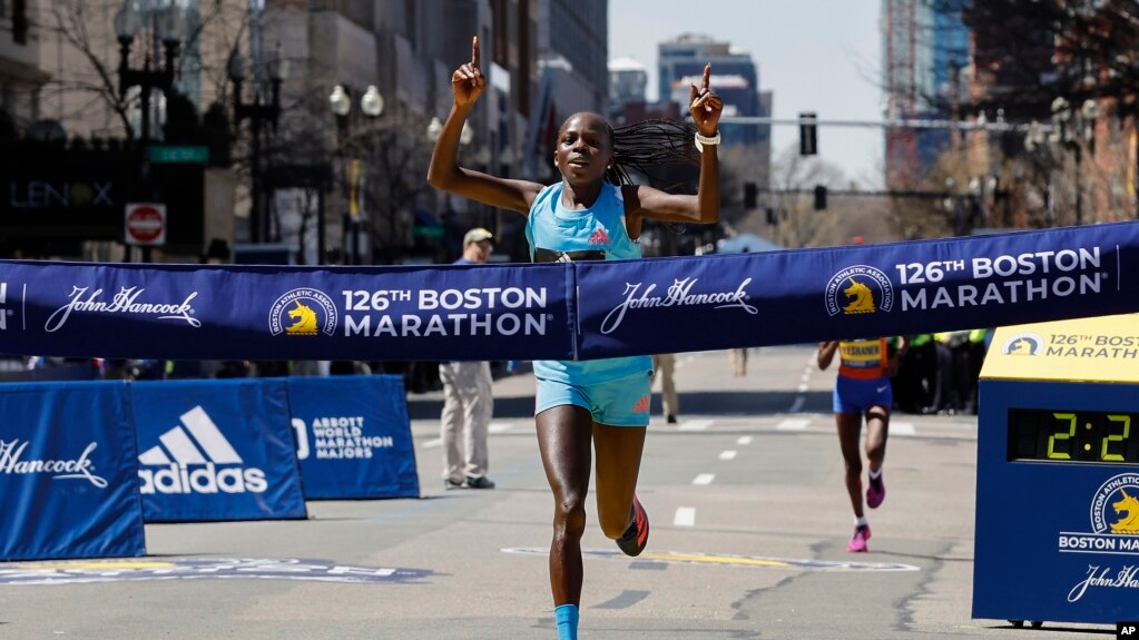 Peres Jepchirchir, of Kenya, crosses the finish line to win the women's division of the 126th Boston Marathon, Monday, April 18, 2022, in Boston. (AP Photo/Winslow Townson)