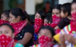 Members of the Zapatista National Liberation Army, EZLN, attend an event marking the 25th anniversary of the Zapatista uprising in La Realidad, Chiapas, Mexico, Jan. 1, 2019.