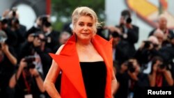 FILE - French actor Catherine Deneuve poses at the red carpet for the movie "The Truth" (La Verite) presented in competition at the 76th Venice Film Festival, in Venice, Italy, Aug. 28, 2019. 