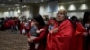 Confederated Tribes of Siletz Indians member Ramona Hudson looks up as her cousin Aurora Chulik-Ruff, 12, holds her 5-month-old brother, Bear Chulik-Moore, as they walk during a dance dedicated to missing and murdered Indigenous women on Nov. 16, 2024, in Lincoln City, Ore. 