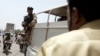 FILE - A soldier stands guard in Karachi, Pakistan, May 13, 2015. The military has been accused by opposition parties in Pakistan of kidnapping a senior police official to force him to arrest an opposition leader.