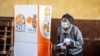 A woman walks out of a polling booth to cast her vote in general elections in Maputo, Mozambique, Oct. 9, 2024.