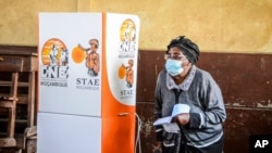 A woman walks out of a polling booth to cast her vote in general elections in Maputo, Mozambique, Oct. 9, 2024.