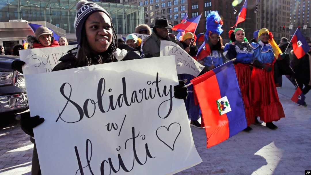 FILE - In this Jan. 26, 2018 file photo, Haitian activists and immigrants protest on City Hall Plaza in Boston over the Trump administration's move to cut off permission for thousands of Haitians to live in the U.S. through the TPS program.