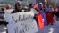FILE - In this Jan. 26, 2018 file photo, Haitian activists and immigrants protest on City Hall Plaza in Boston over the Trump administration's move to cut off permission for thousands of Haitians to live in the U.S. through the TPS program.