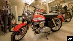 FILE - Marty Rosenblum, a historian for Harley Davidson, points to Elvis Presley's first motorcycle in a storage room at the Milwaukee-based motorcycle company, Wisconsin, Oct. 16, 1995.