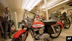 FILE - Marty Rosenblum, a historian for Harley Davidson, points to Elvis Presley's first motorcycle in a storage room at the Milwaukee-based motorcycle company, Wisconsin, Oct. 16, 1995.