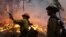 Fire crew members stand watch near a controlled burn operation as they fight the Rim Fire near Yosemite National Park in California, Sept. 2, 2013.