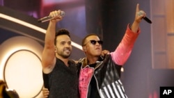 FILE - This April 27, 2017, photo shows singers Luis Fonsi, left, and Daddy Yankee during the Latin Billboard Awards in Coral Gables, Florida. The success of their hit song "Despacito," has stretched beyond its Latin audience, becoming the year’s most recognized song.