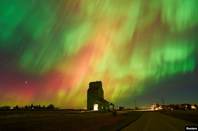 FILE - The aurora borealis, also known as the northern lights, light up the sky over an old grain elevator in Brant, Alberta, Canada October 7, 2024. (REUTERS/Todd Korol)