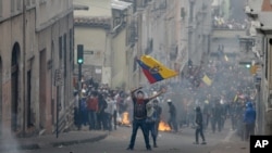 Demonstrators clash with riot police during protests after Ecuador's President Lenin Moreno's government ended four-decade-old fuel subsidies, in Quito, Ecuador, Oct. 3, 2019.