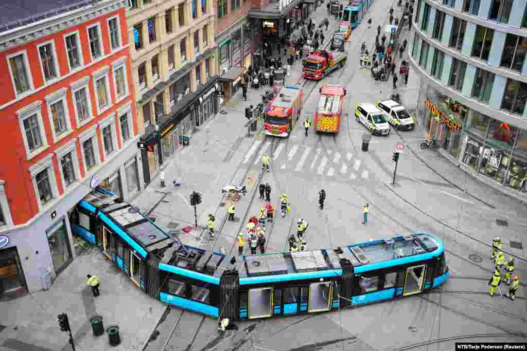 First responders work after a tram on Storgata derailed and crashed into a building that sells Apple products, injuring several onboard - none seriously, according to emergency services in Oslo, Norway.