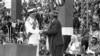 Britain's Prince Philip, the Duke of Edinburgh, hands the Instruments of Independence to Kenya's Prime Minister Jomo Kenyatta during the independence ceremony at Uhuru Stadium, Nairobi, Dec. 12, 1963. 