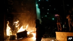 Protesters set fires at the 3rd Precinct of the Minneapolis Police Department, Thursday, May 28, 2020, in Minneapolis. Violent protests over the death of George Floyd, the black man who died in police custody, broke out in Minneapolis for a third…
