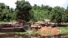 FILE - Logs lie next to a rusting barge on the banks of the Congo River, Oct. 7, 2004. Greenpeace reported at the time that the president of the Democratic Republic of the Congo was finally backing a largely ignored ban on new logging that had been approved in 2002. But several illegal permits have been issued since then. 