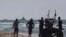 FILE—A ship belonging to the Open Arms aid group approaches the shores of Gaza towing a barge with 200 tons of humanitarian aid on Friday, March 15, 2024. The ship set sail Tuesday from Cyprus to inaugurate a sea route to get desperately needed aid into the war-wracked enclave.
