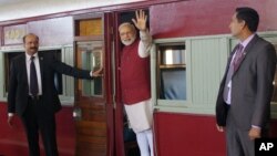 Indian Prime Minister Narendra Modi waves from a train carriage at Pentrich Railway station in Pietermaritzburg, South Africa, July 9, 2016. Modi took the same trip that Mahatma Gandhi took in 1893 when he was thrown off the train because of his race.