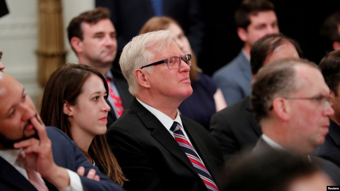 FILE - Gateway Pundit publisher Jim Hoft listens as U.S. President Donald Trump speaks during a "social media summit" meeting with prominent conservative social media figures in the East Room of the White House in Washington, July 11, 2019. 