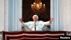 Pope Benedict waves to the faithful from the balcony of his summer residence in Castel Gandolfo, Feb. 28, 2013. 