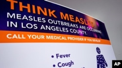  A poster released by Los Angeles County Department of Public Health is seen as experts answer questions regarding the measles response and the quarantine orders in Los Angeles, April 26, 2019.