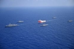 FILE - A handout photo released by the Turkish Defense Ministry Aug. 12, 2020, shows Turkish seismic research vessel Oruc Reis (C) as it is escorted by Turkish Naval ships in the Mediterranean Sea, off Antalya, Aug. 10, 2020.