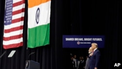 President Donald Trump stands on stage with Indian Prime Minister Narendra Modi at NRG Stadium, Sept. 22, 2019, in Houston, during a "Howdy Modi: Shared Dreams, Bright Futures" event. 