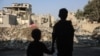 Children stare at the destruction following an Israeli strike in the Nuseirat refugee camp in the central Gaza Strip on Nov. 7, 2024.