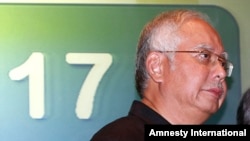 Malaysian Prime Minister Najib Razak, walks away after a media conference at a hotel in Kuala Lumpur International Airport in Sepang, Malaysia, July 18, 2014. 