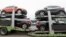 FILE - Cars made by GM Korea are seen on trucks in a yard of GM Korea's Bupyeong plant before they are transported to a port for export, in Incheon, west of Seoul, Aug. 9, 2013. 