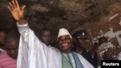 Sierra Leone's incumbent President Ernest Bai Koroma waves to supporters after voting in the capital Freetown, November 17, 2012.